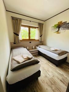 een slaapkamer met twee bedden en een raam bij Chalet Sunshine in Livigno
