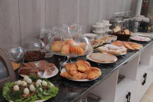 a buffet with many different types of bread and pastries at Nur Makon Hotel in Tashkent