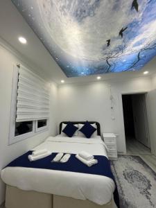 a bedroom with a large bed with a painting on the ceiling at Dereli Suit Delux Ayder in Rize