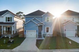 a blue house with two white houses at Mins to the Beach/King Beds/Arcade-Snowbird Deals! in Perdido Key