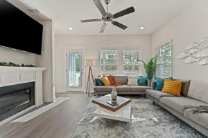 a living room with a couch and a fireplace at Mins to the Beach/King Beds/Arcade-Snowbird Deals! in Perdido Key