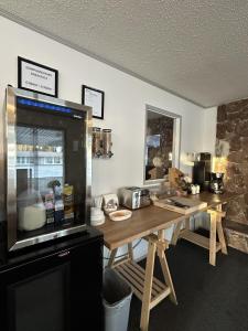 a kitchen with a wooden table with a counter top at Howard Johnson by Wyndham Edson in Edson