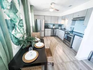 a kitchen with a table with two plates on it at Moody Gardens Oasis (Unit 8) in Galveston