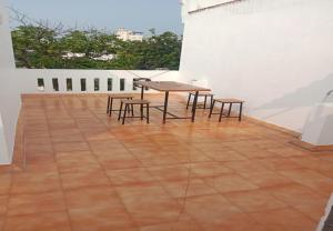 a table and two chairs on a patio at Rue Heritage inn in Puducherry