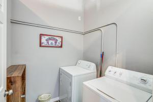 a small laundry room with a washer and dryer at Downtown Del Norte Apartment Ski, Hike and Shop! in Del Norte