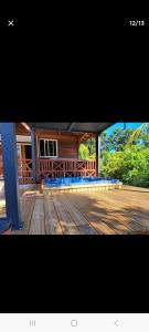 a porch of a house with a wooden deck at Maison de 2 chambres avec jardin clos et wifi a Petit Bourg in Petit-Bourg