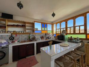 a kitchen with a stove and a counter top at Cozy Surf House in Taghazout