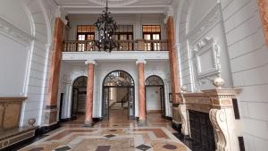 a large hallway with a chandelier in a building at Budapest Parlament Welcome Apartment in Budapest