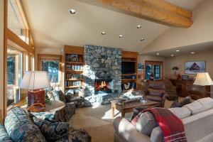 a large living room with a stone fireplace at Ski Way Home Steps to the Warm Springs Lift in Ketchum
