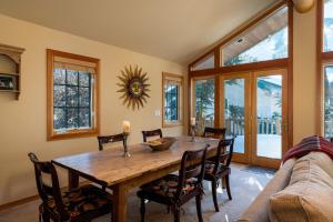 a dining room with a wooden table and chairs at Ski Way Home Steps to the Warm Springs Lift in Ketchum