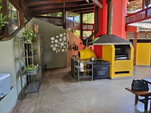 a kitchen with a stove and a yellow oven at Chacara com Wi-Fi e piscina em Ouro Verde De Goias in Matão