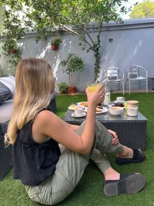 a woman sitting at a table with a bowl of food at Enjoy Hostel in Santiago