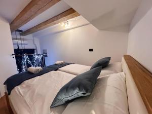 a bedroom with a large bed with gray pillows at Apartman LA CASA 77B in Ljubljana