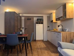 a small kitchen with a table and a refrigerator at Apartman LA CASA 77B in Ljubljana