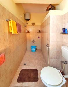 a bathroom with a toilet and a sink at Ivory - Vintage Haven in Bangalore