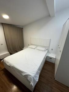 a bedroom with a large white bed in it at Stone Residence in Braşov