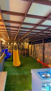 a play room with a playground with a slide at Bait Alsalam in Sayq
