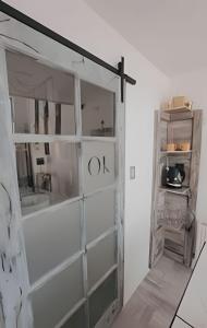 a sliding glass door in a room with a shelf at okeyloft Coyhaique 1 in Coihaique