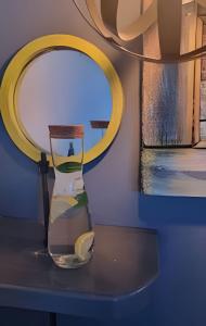 a vase sitting on a table with a mirror at okeyloft Coyhaique 1 in Coihaique