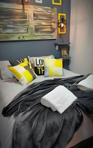 a bedroom with a bed with yellow and black pillows at okeyloft Coyhaique 1 in Coihaique