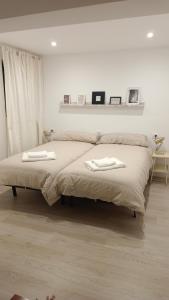 1 dormitorio con 1 cama con 2 toallas en Apartamento Tajinaste con vistas al mar y la montaña y wifi gratis, en Los Realejos