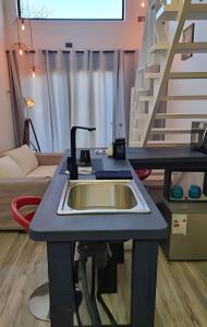 a kitchen counter with a sink in a room at okeyloft Coyhaique 5 in Coihaique +17 photos