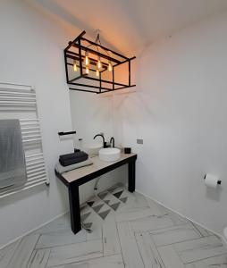 a bathroom with a sink and a light fixture at okeyloft Coyhaique 6 in Coihaique