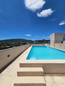 a swimming pool on the roof of a building at Apartamento Esquiu C in Villa Carlos Paz