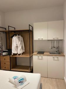 a kitchen with white cabinets and a counter top at Maritime Suites in Hersonissos