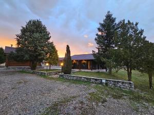 a house with a gravel driveway in front of it at Orino Livadi Mount Villa IV in Arachova