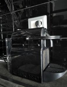 a black toaster sitting on top of a counter at Ziggy House in Turin