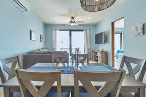 a dining room and living room with a table and chairs at Casa El Ocaso in Cabo San Lucas