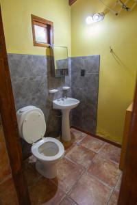 a bathroom with a toilet and a sink at Alojamiento Del Bosque in Ushuaia