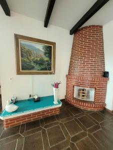 a brick fireplace with a table in a room at Casa da Edna in Guarujá
