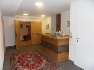 a hallway with a counter in a room with a rug at Haus Erhart in Ladis