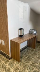 a coffee maker on a wooden desk in a room at Holiday Sai Hotel in San Andrés