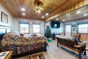 a bedroom with a bed and a christmas tree in it at The Gambrel House in Pulteney