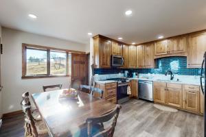 a kitchen with wooden cabinets and a wooden table at The Gambrel House in Pulteney