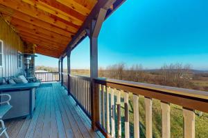 a deck with a view of the mountains at The Gambrel House in Pulteney