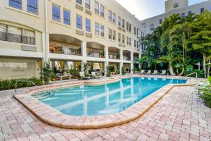a large swimming pool in front of a building at Sunrise Suite #2232 in Palm Beach