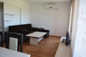 a living room with a couch and a table at Guest House Georgievi in Primorsko