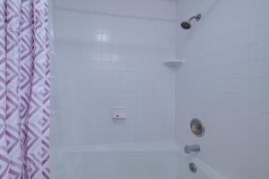 a bathroom with a shower with three fixtures on the wall at Bellaire Vacation Rental - Ski Shuttle Access! in Bellaire