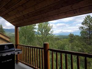 a screened in porch with a view of the mountains at Chicamon Springs Lodge by FantasticStay in Kimberley