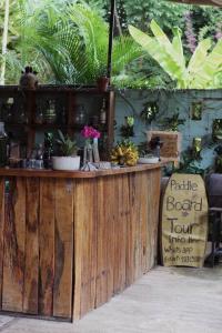 a wooden bar with a sign in front of it at Jungla Bacalar in Bacalar