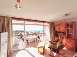 a living room with a view of a balcony at Tenerife Flamingo in Palm-mar