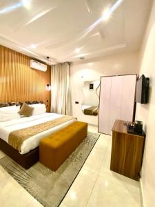 a bedroom with a large bed and a television in it at De Fivez in Lagos