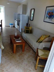 a living room with a couch and a table at Maria's Sea View Apartments in Mousata