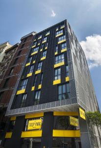 a tall building with yellow and black windows at Trip Park Hotel in Istanbul