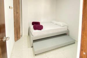 a bed with two pillows on it in a room at Apartamento Balcón 302 in San Luis