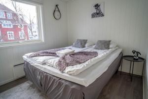 a bed sitting in a room with a window at City Center Getaway 9 by Berti in Stavanger